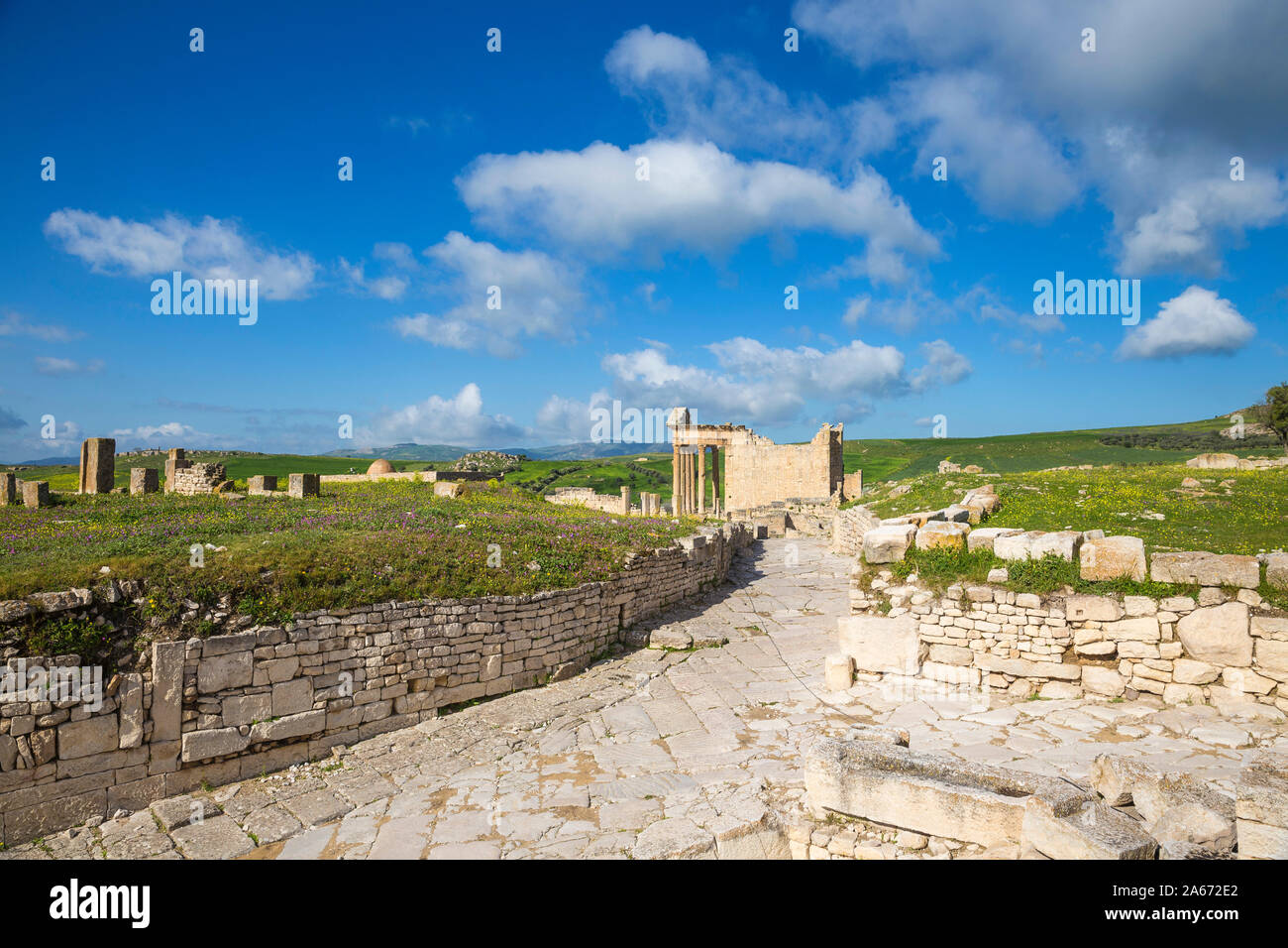 Tunisia, Teboursouk, Dougga archaeological site, Roman road leading to The Capitol, a Roman temple, an ancient Mosque to the left Stock Photo