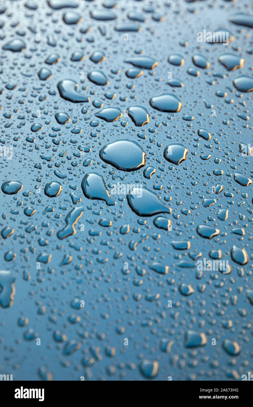 Water droplets on mertallic blue background Stock Photo