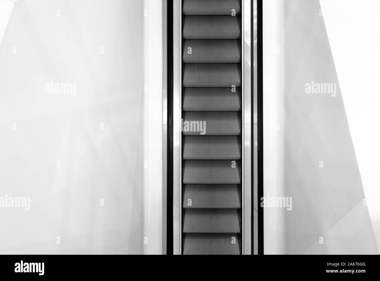 Escalator in white color wall,Moving up staircase. electric escalator Stock Photo