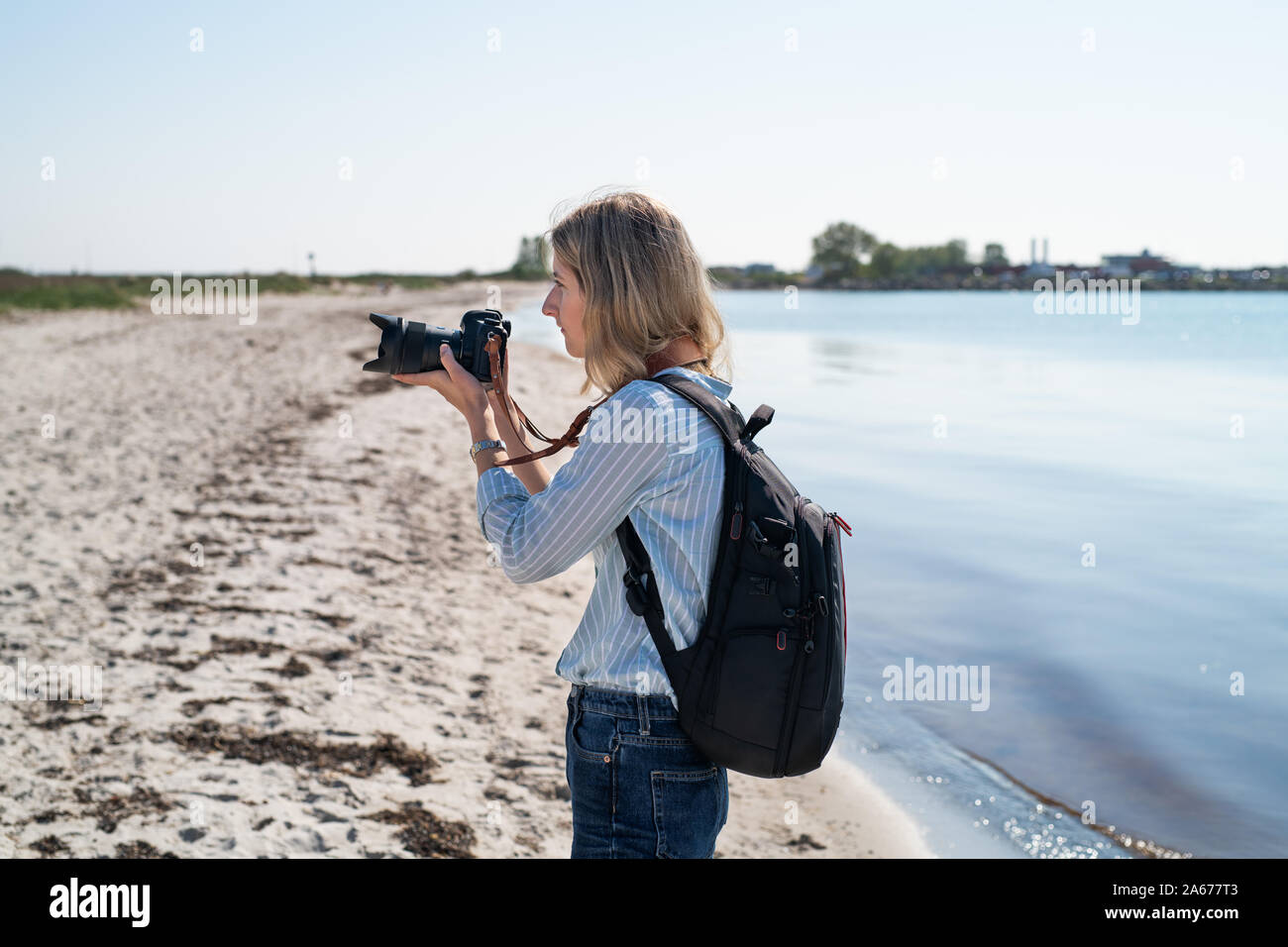 Woman photographing from a beach Stock Photo