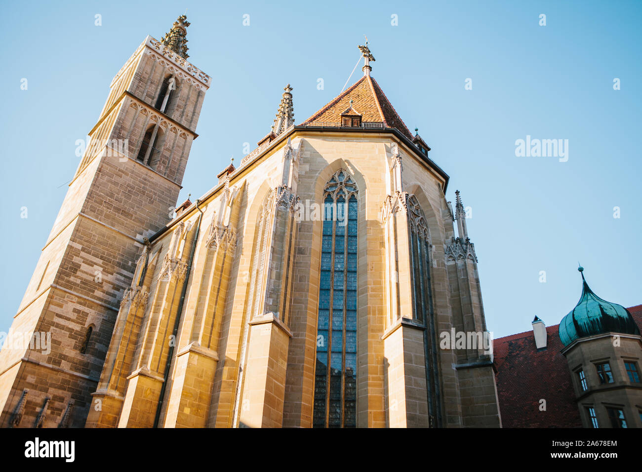St. Jacob's Church in Rottenbourg ob der Tauber in Germany against a blue sky. Religious place and city attraction. Stock Photo