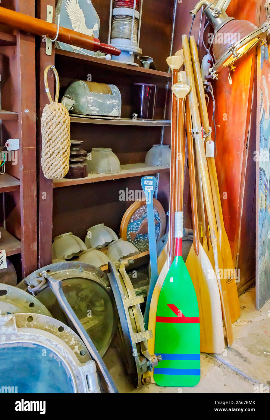 Wooden canoe paddles, nautical souvenirs, and memorabilia are crowded onto shelves, Oct. 6, 2019, in Apalachicola, Florida. Stock Photo