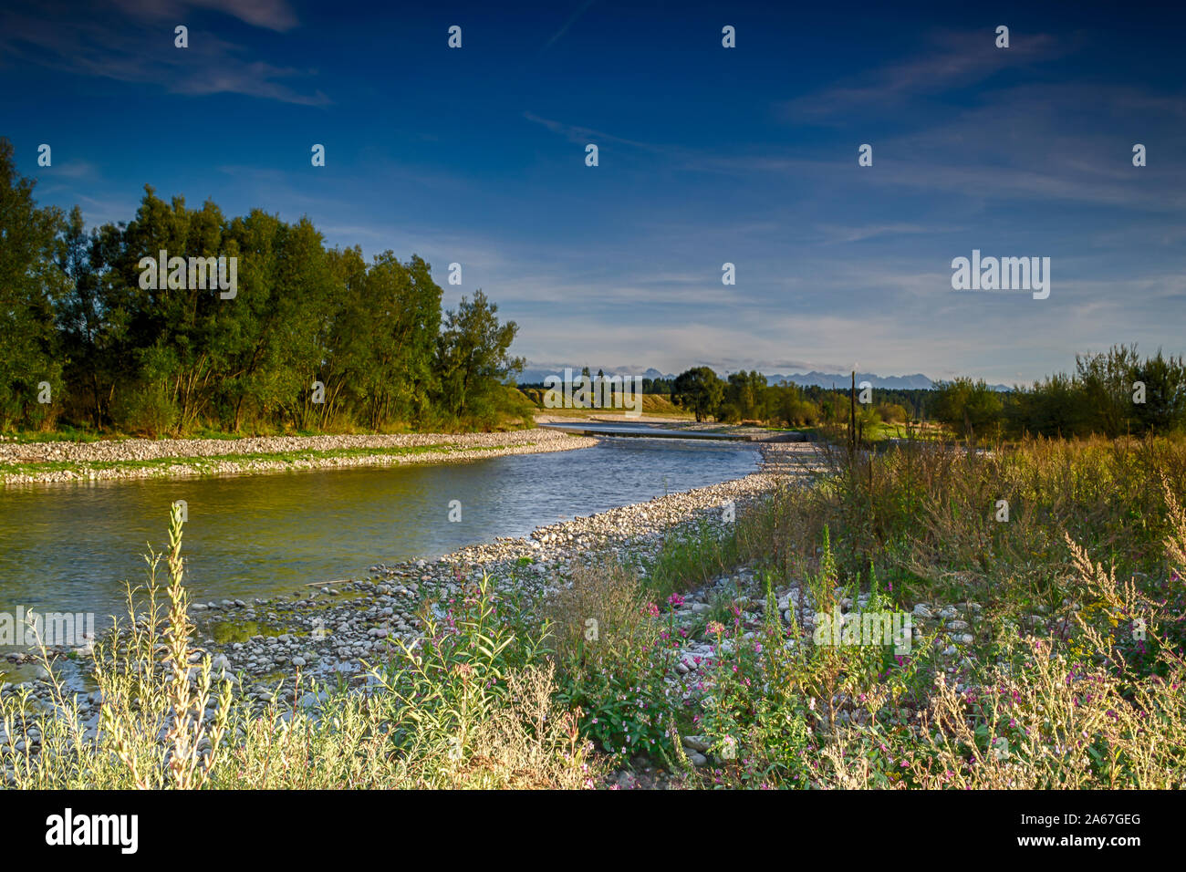 View of the Czarny Dunajec river and distant mountains. Stock Photo