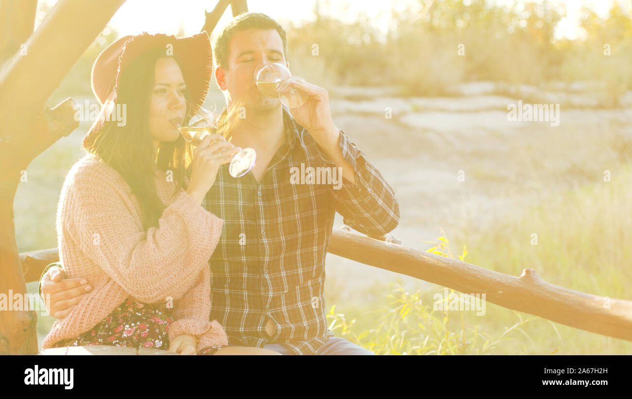 Wine tasting in a beautiful sun flares at the sunset. Stock Photo