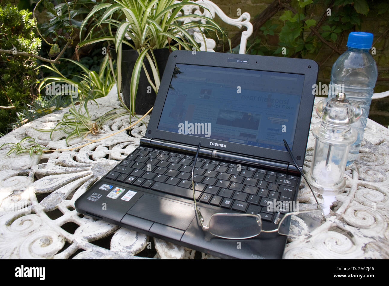 A Toshiba netbook waiting on a garden table Stock Photo