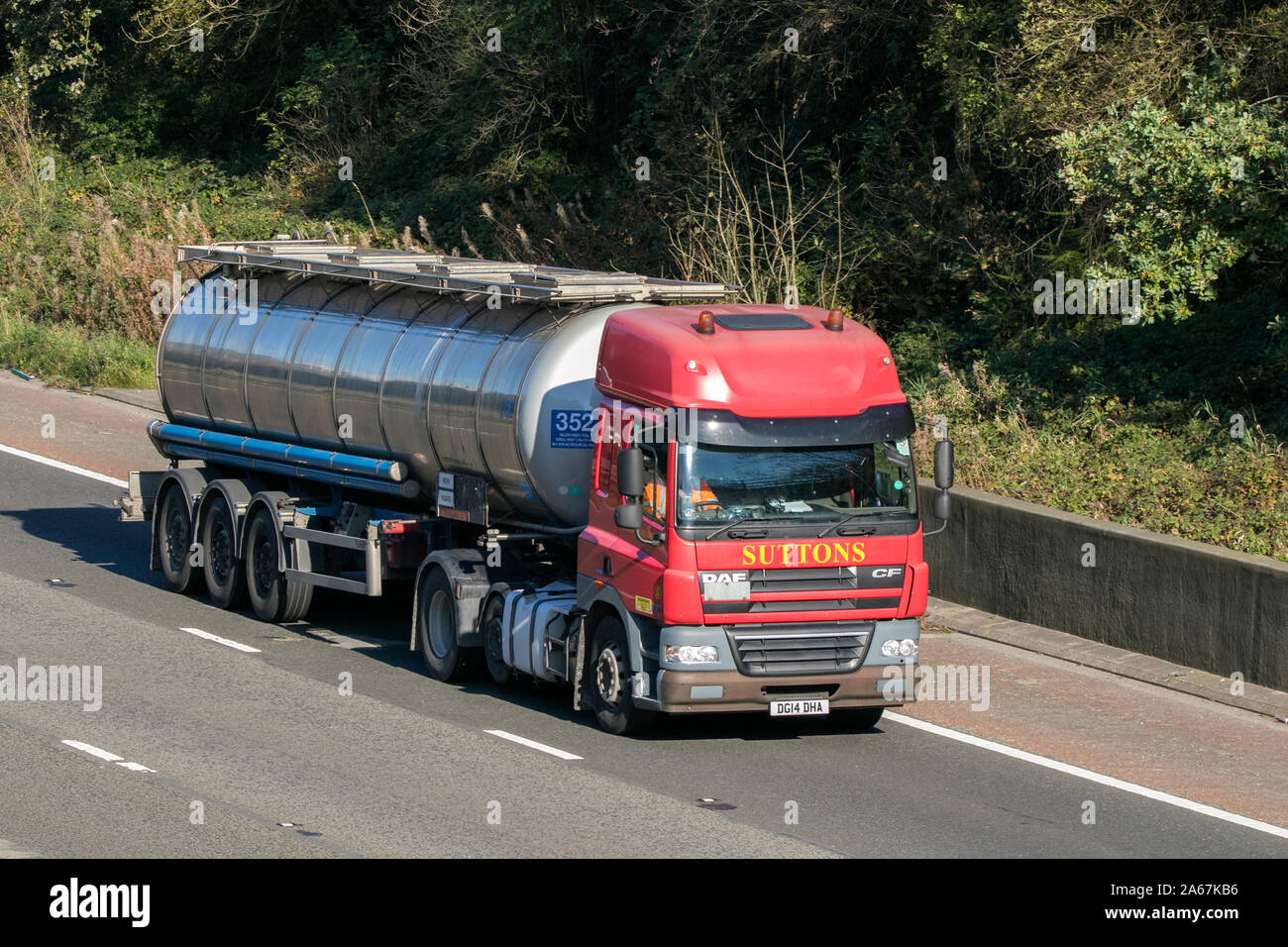 A Suttons tanker transport articulated DAF CF semi truck traveling on the M6 motorway near Preston in Lancashire, UK Stock Photo