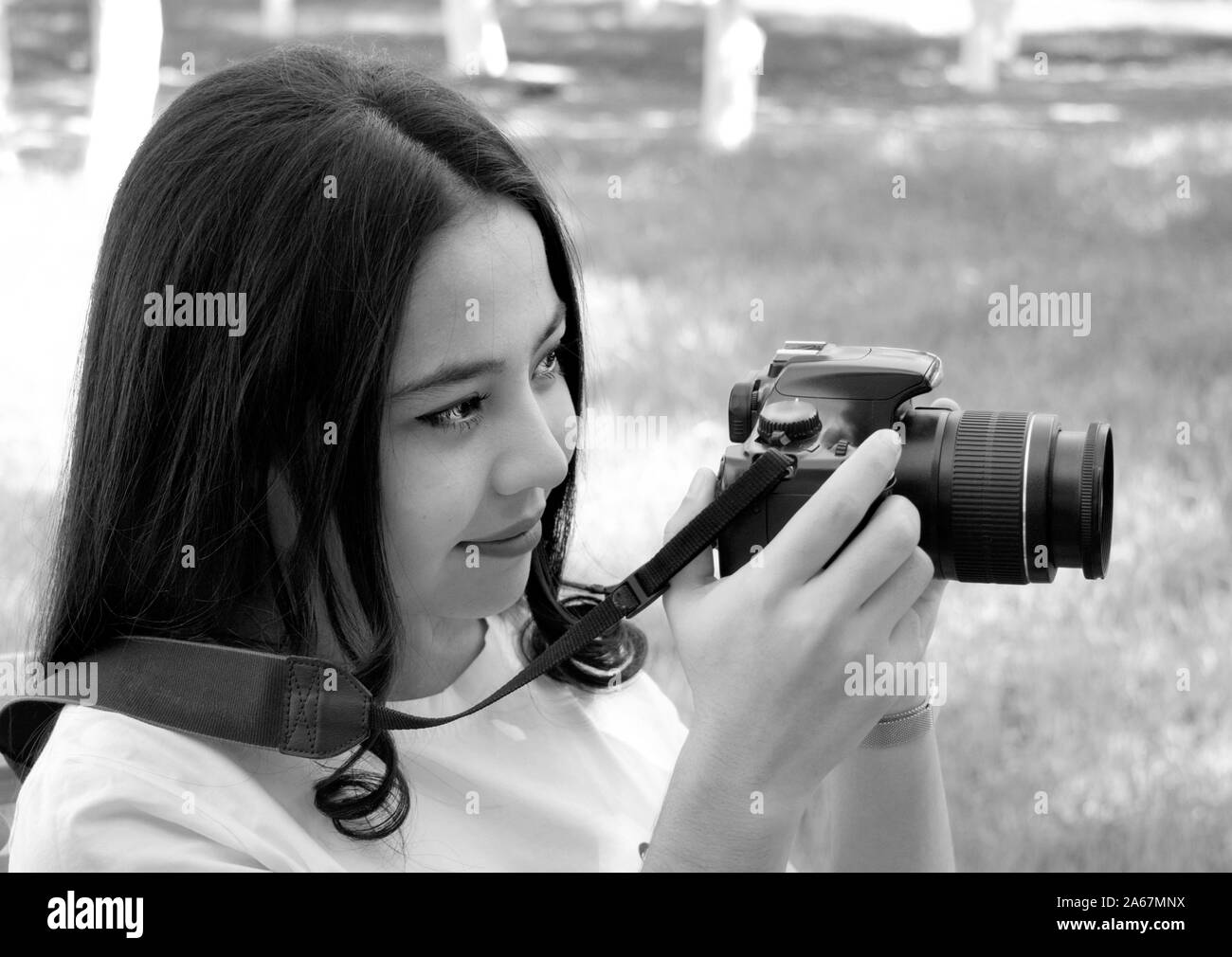photo with the image of a beautiful young girl with a photo camera Stock Photo