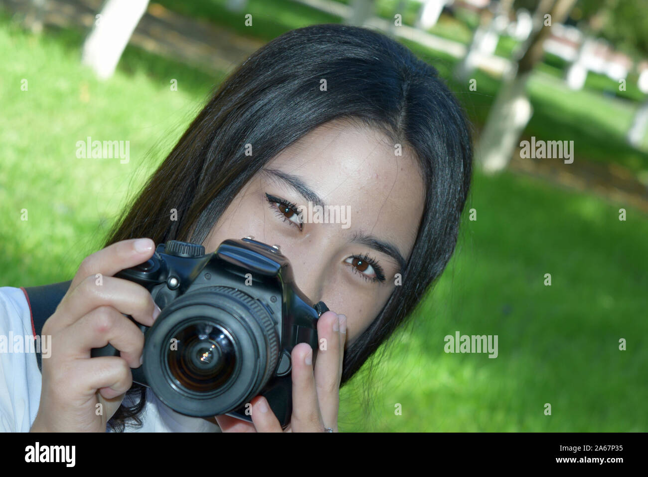 photo with the image of a beautiful young girl with a photo camera Stock Photo