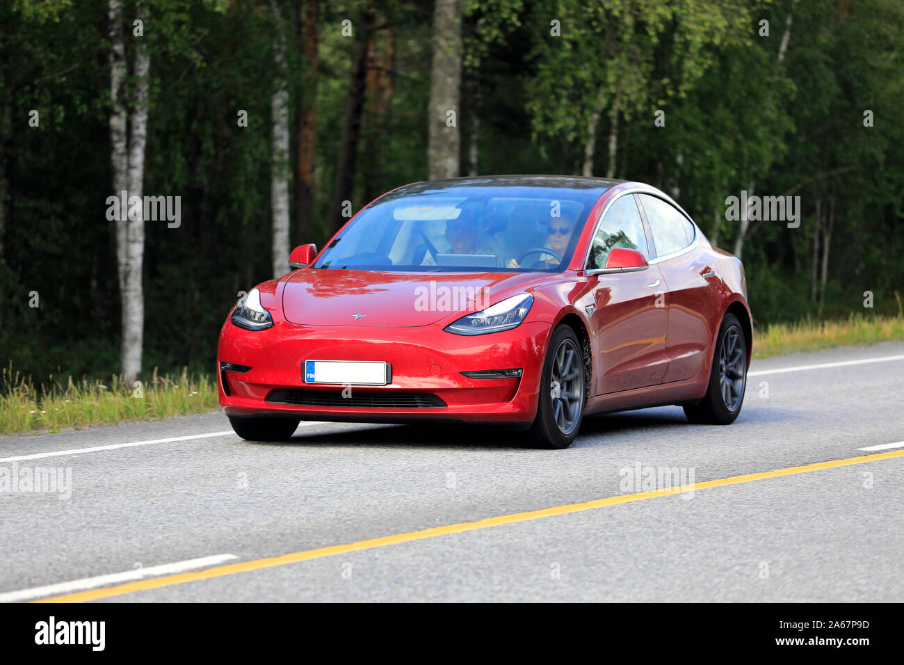 Tesla Model 3 electric car on road. The Model 3 has full self-driving capability that can be optionally enabled. Raseborg, Finland. July 12, 19. Stock Photo