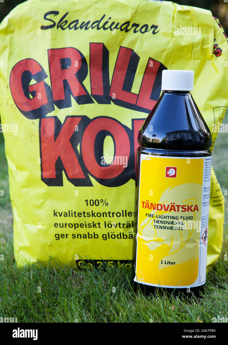 Grill charcoal and sparkling liquid in front of a burning grill.Photo