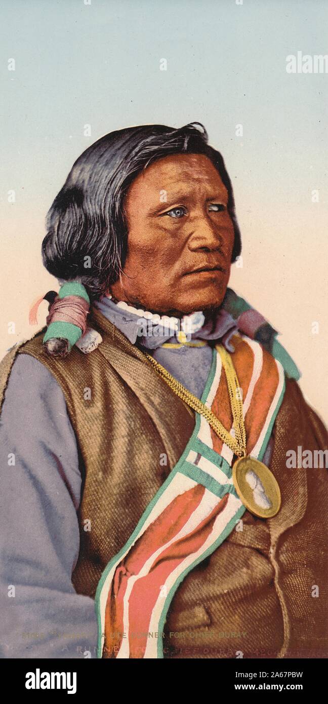 Photochrom image with a three-quarter profile view, from the waist up, of a Native American man wearing a sash and a large gold pendant, captioned ''Yamapi, ' A Ute Runner for Chief Ouray, ' photographed in Colorado, 1895. () Stock Photo