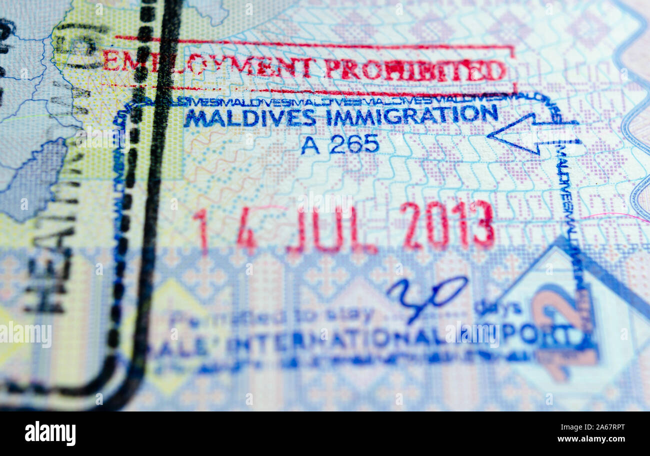 Maldives entry visa stamp in a passport. Concept for travel and holidays. Macro photo with selective focus. Stock Photo