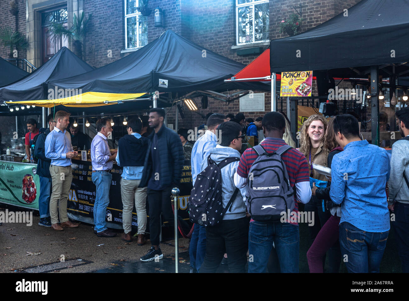 Customers at food stalls on Tottenham Court Road, London, England, UK. Stock Photo