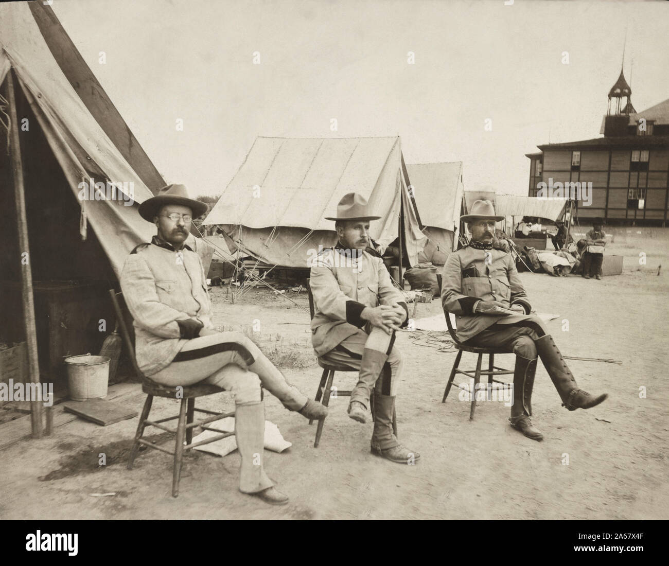 Colonel Theodore Roosevelt, Leonard Wood, and Alexander O. Brodie Sitting in front of Camp Tents, San Antonio, Texas, USA, Photograph by Paul Thompson, 1898 Stock Photo