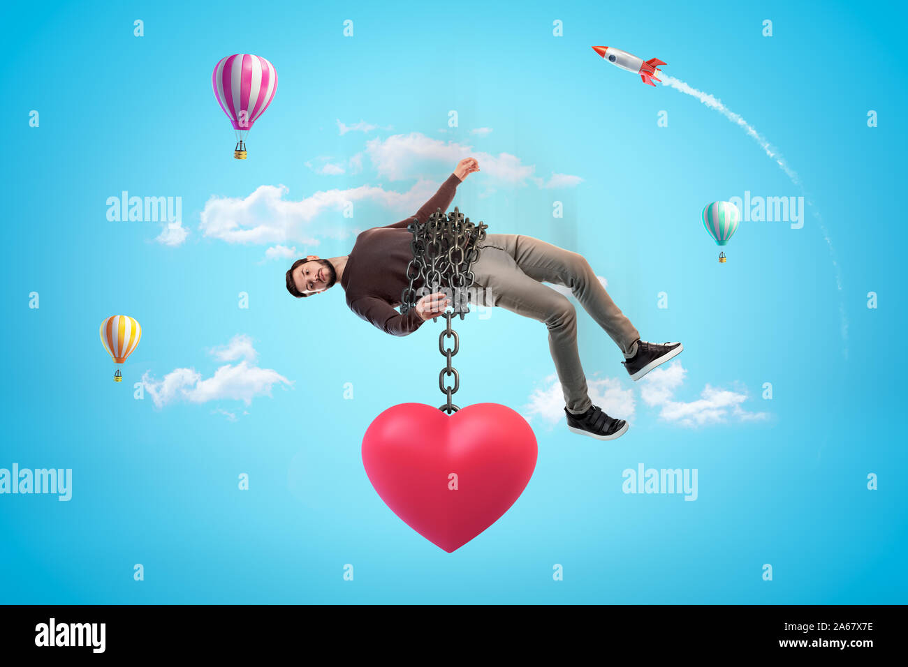 Man in blue sky bound with chains to huge red heart which is pulling