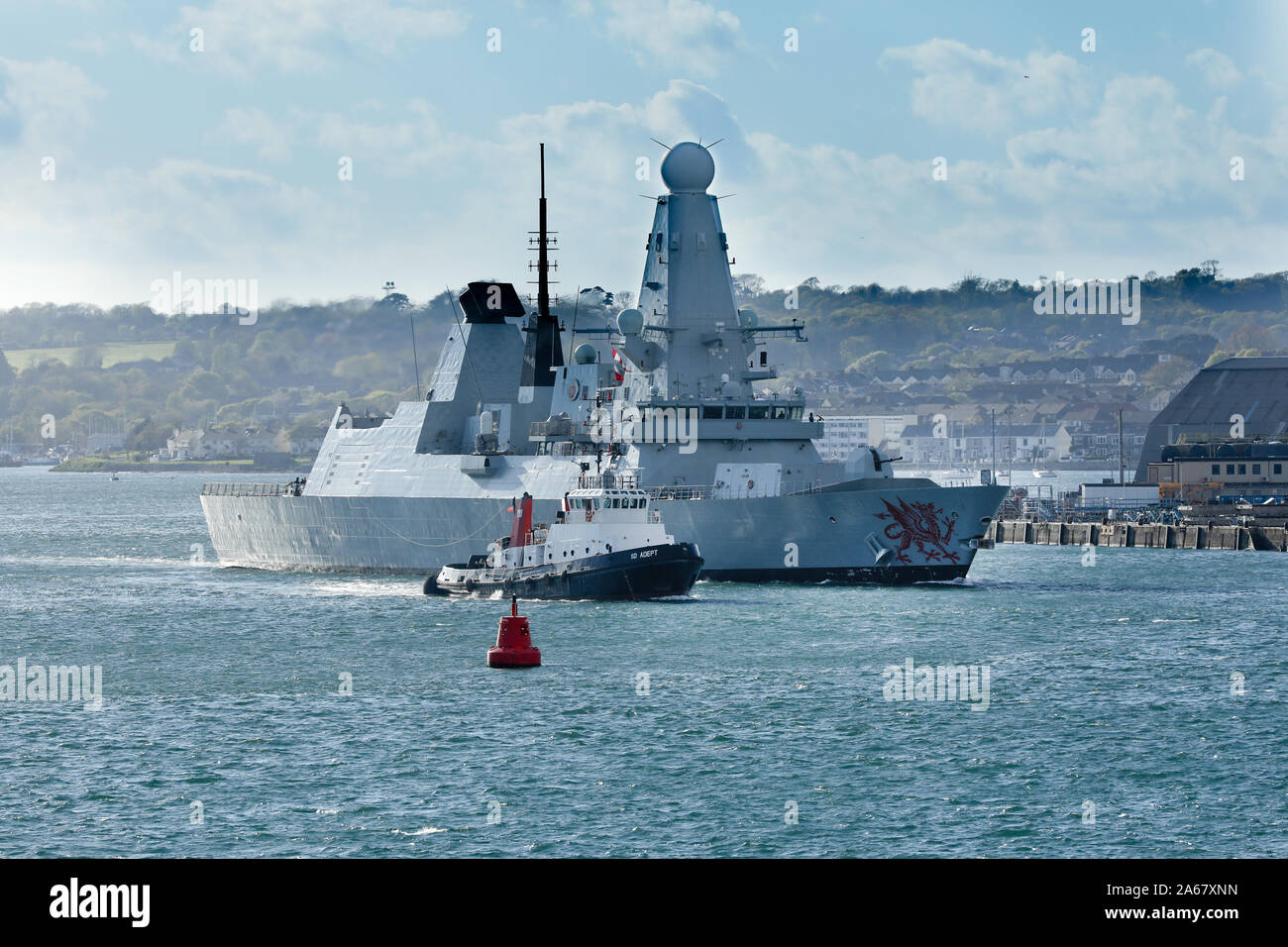 HMS Dragon a Type 45 destroyer leaving Plymouth with accompanying SERCO tug Adept Stock Photo