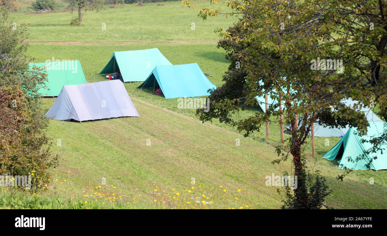 Scout camp with many tents in mountains in late summer Stock Photo