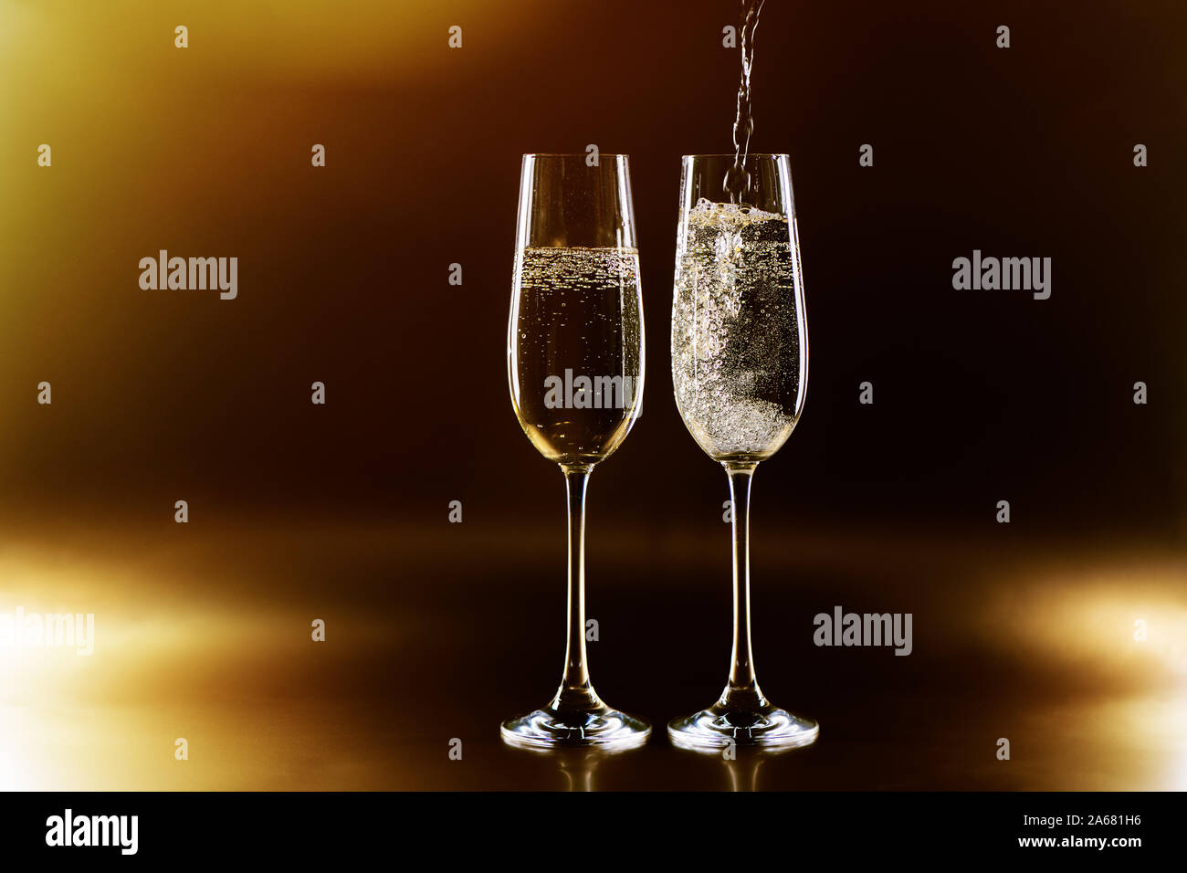 Two champagne glasses clinking hi-res stock photography and images - Alamy