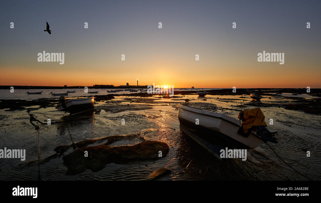 Beached Boats at Sunset La Caleta Cadiz Andalusia Spain Stock Photo