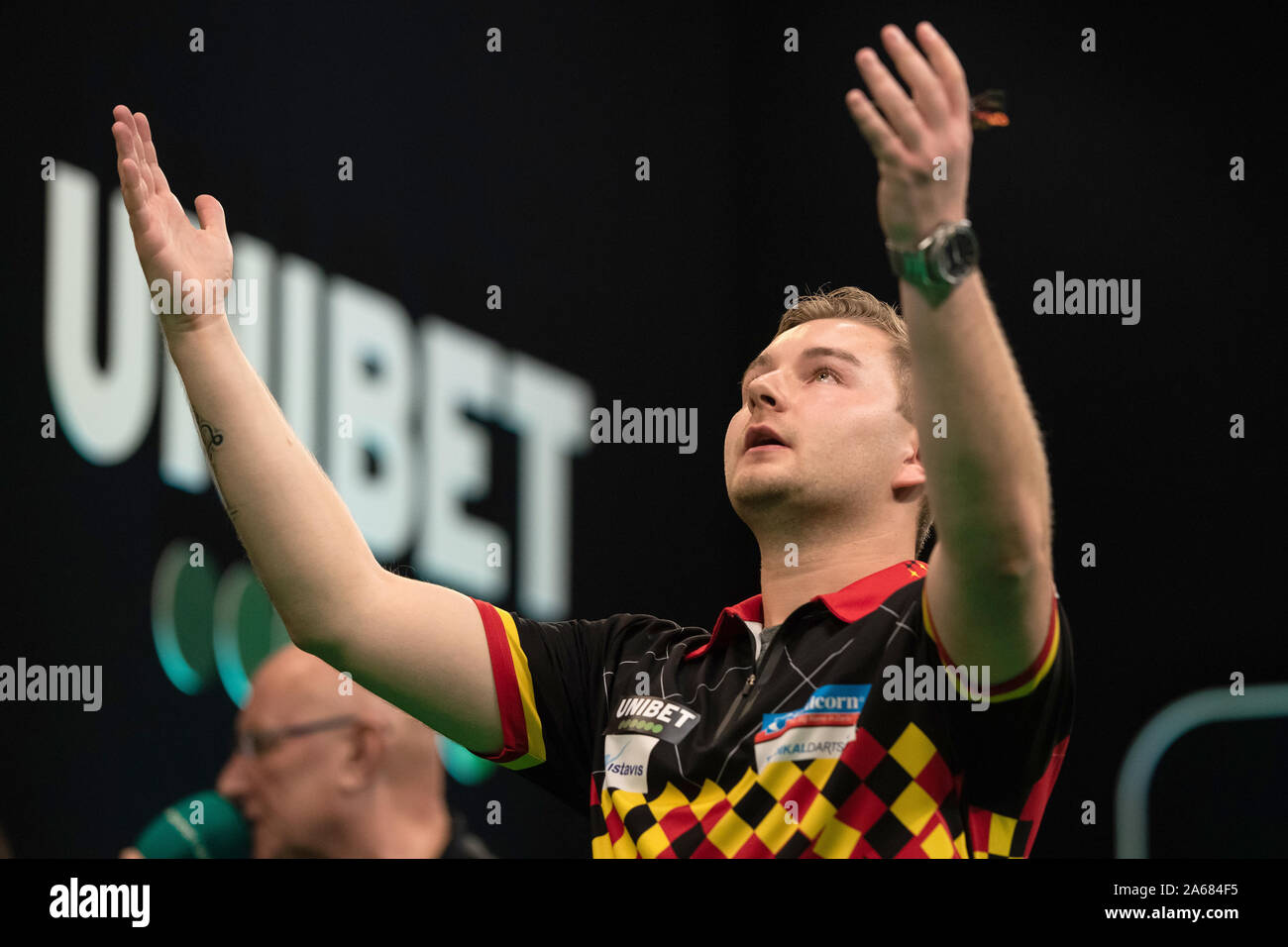 24 October 2019, Lower Saxony, Göttingen: Darts: PDC European Championship,  1st round in the Lokhalle. Dave Chisnall from England throws the arrow in  his match against Van den Bergh from Belgium. The