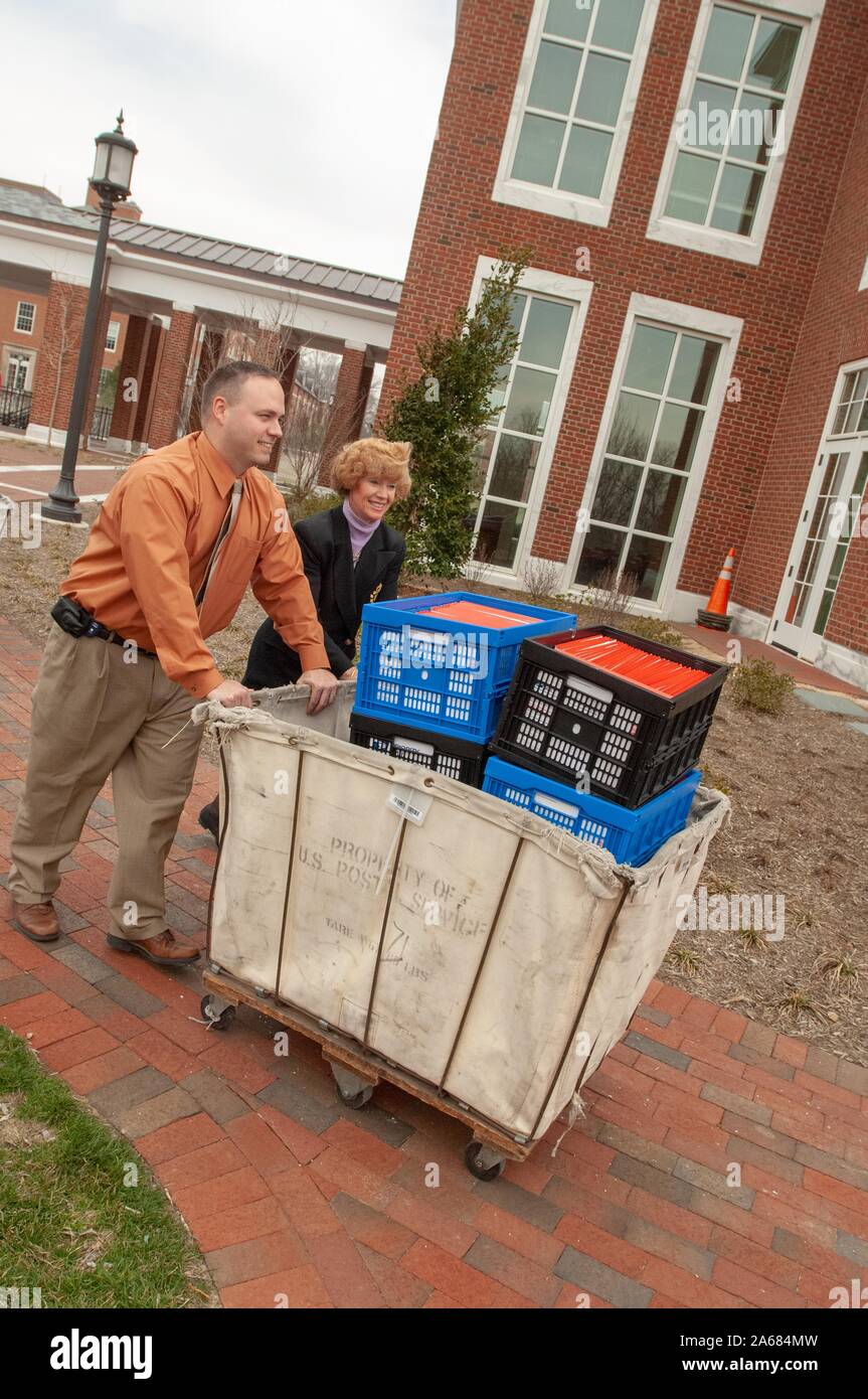 Admissions staff members prepare large mail crates containing acceptance letters and admissions packets on the Homewood Campus of the Johns Hopkins University in Baltimore, Maryland, March 28, 2008. From the Homewood Photography collection. () Stock Photo