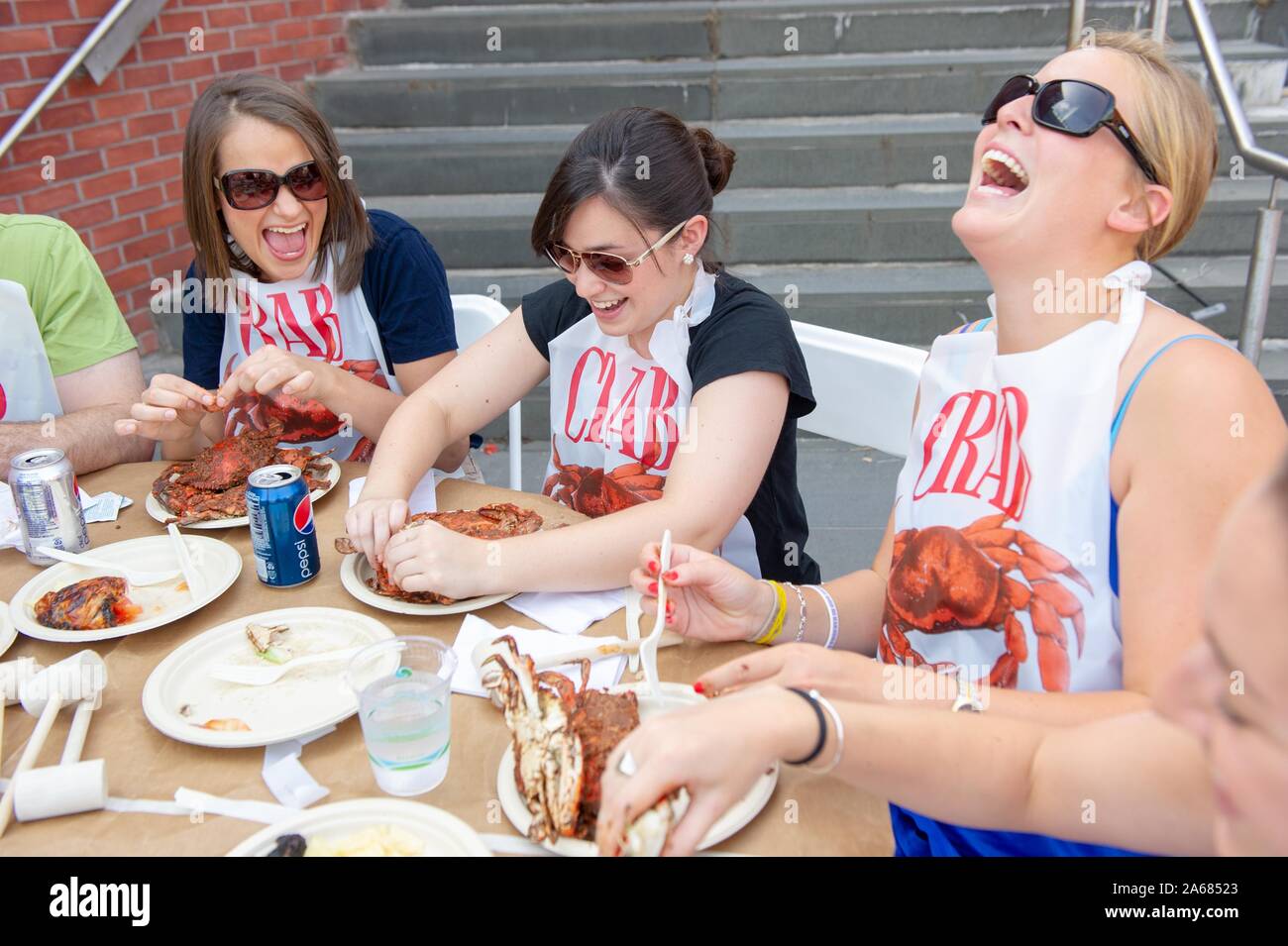 Students participate in a crab feast with the traditional Maryland dish of blue crabs, on the Homewood Campus of the Johns Hopkins University in Baltimore, Maryland, May 21, 2010. From the Homewood Photography collection. () Stock Photo