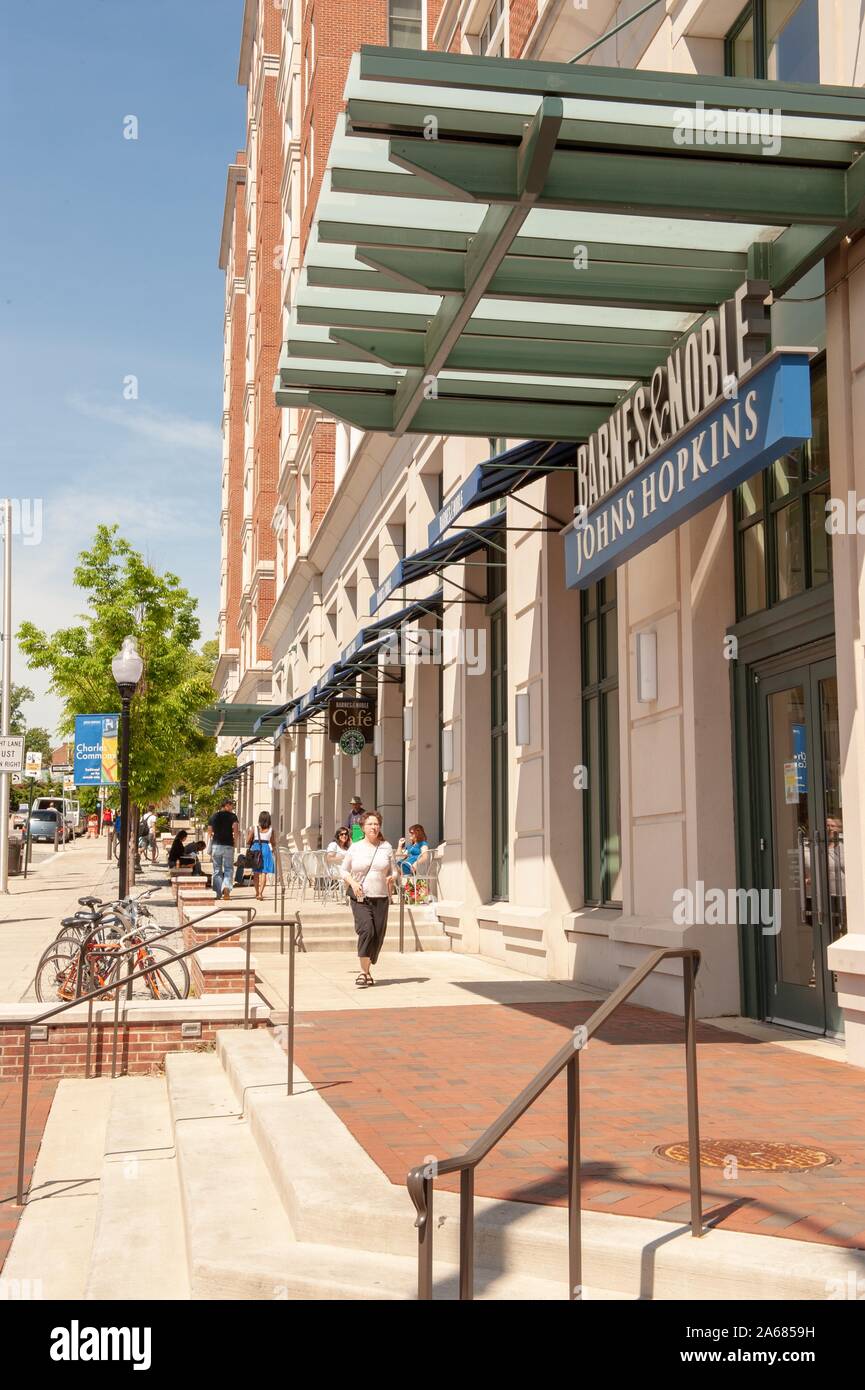 Pedestrians, and people relaxing at outdoor tables, on a sunny day, on a broad sidewalk near a Barnes and Noble associated with the Johns Hopkins University, Baltimore, Maryland, May 7, 2010. From the Homewood Photography Collection. () Stock Photo