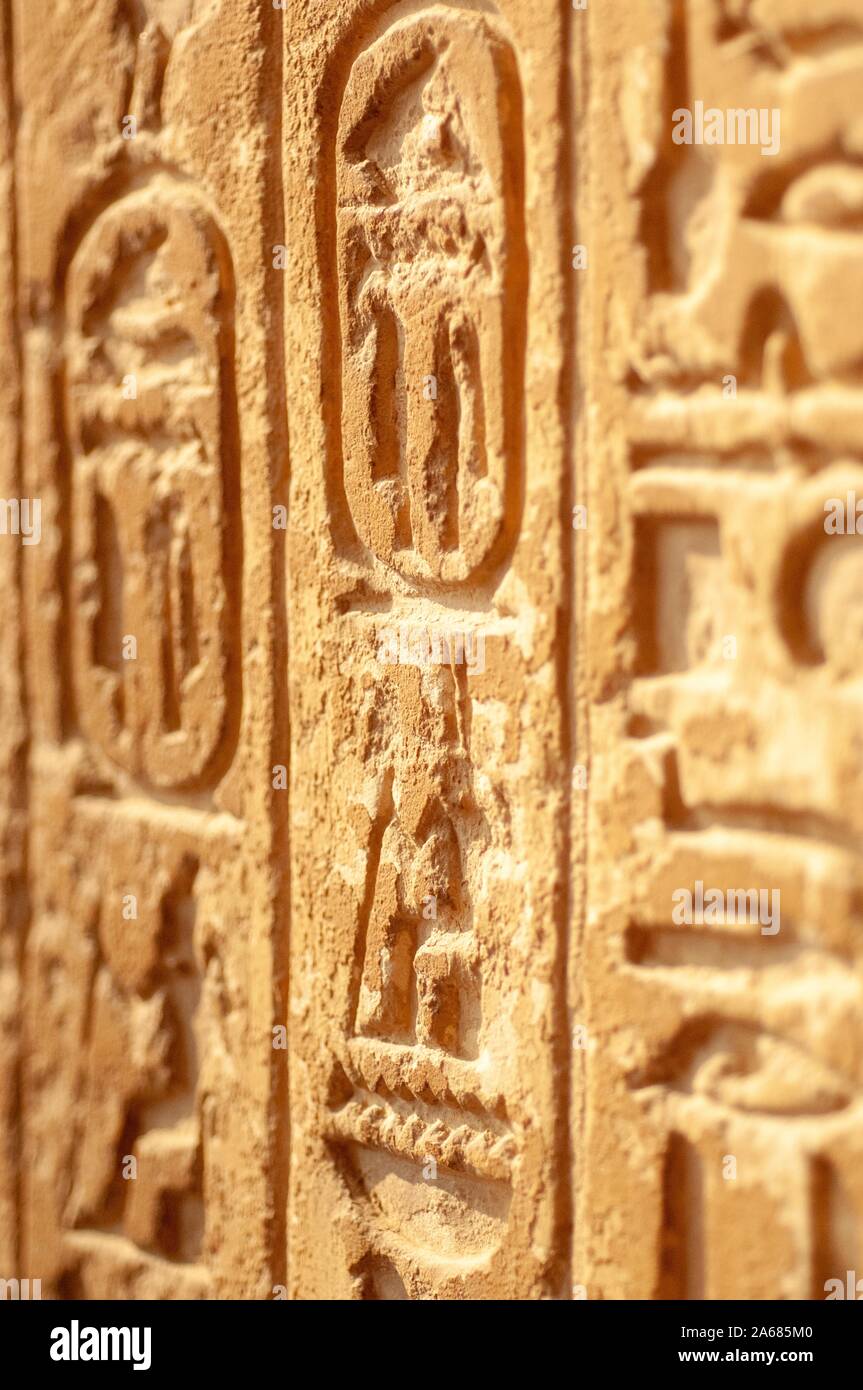 Angled close-up of hieroglyphics, carved vertically on the face of a wall or pillar, Giza, Egypt, January 6, 2008. From the Homewood Photography Collection. () Stock Photo