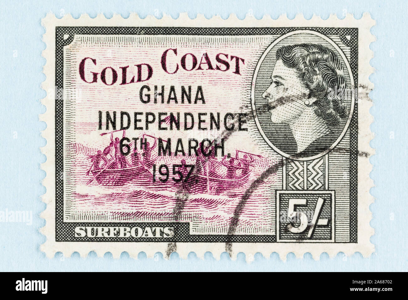 Close up of Gold Coast postage stamp with image of Queen Elizabeth and traditional  surfboats, overprinted with Ghana Independence, March 6, 1957. Stock Photo