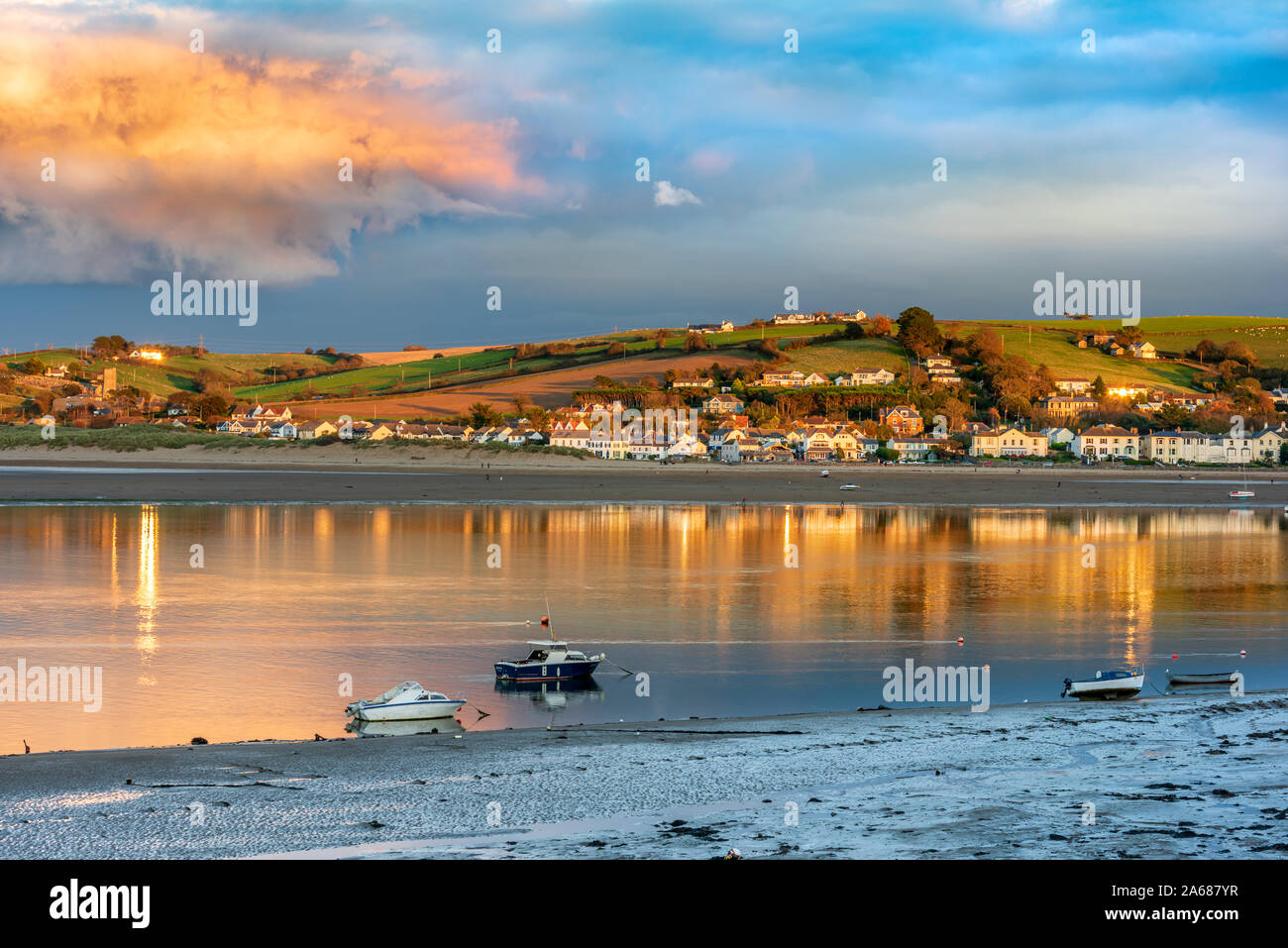 The late afternoon sunshine lights up the shoreline on the River Torridge estuary at Instow in