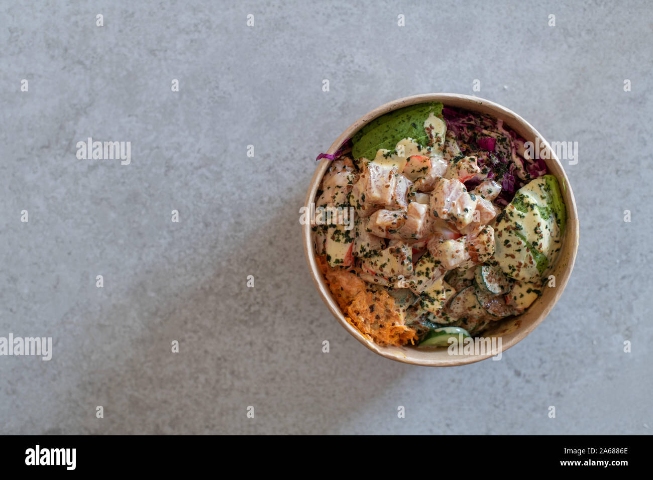 California Poke Bowl with salmon, avocado, crab surimi, carrot, red