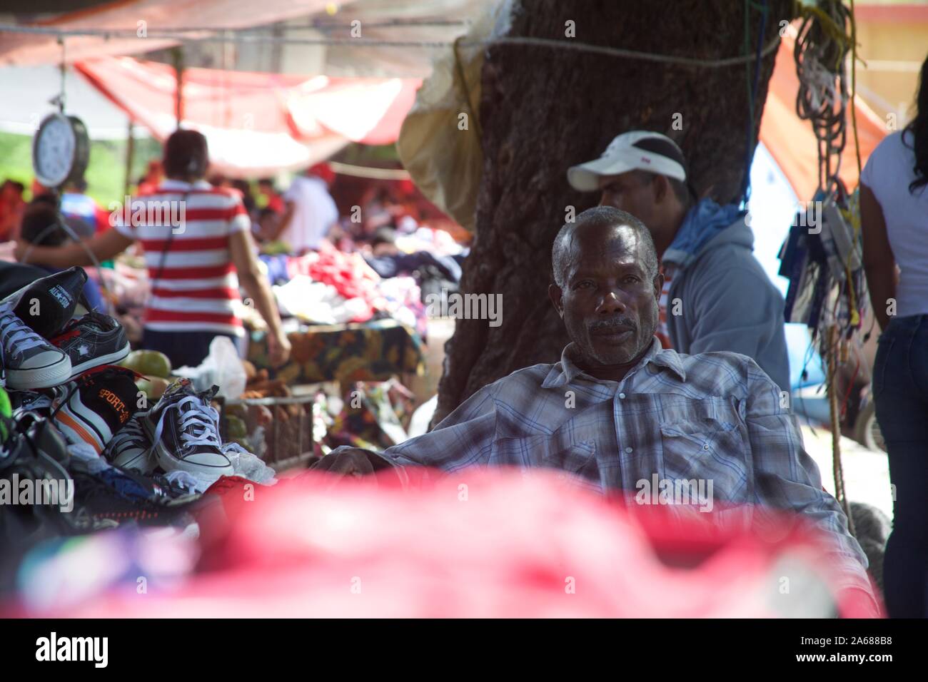 Haitian outdoor market with shoes and clothes venders, in dominican republic Stock Photo