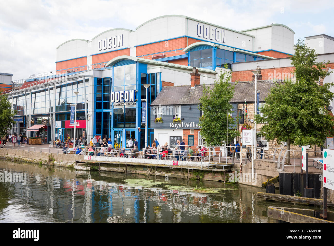 Entertainment complex on Brayford Waterside in Lincoln city England UK including the Odeon and the Royal William IV inn with tourists relaxing over a Stock Photo
