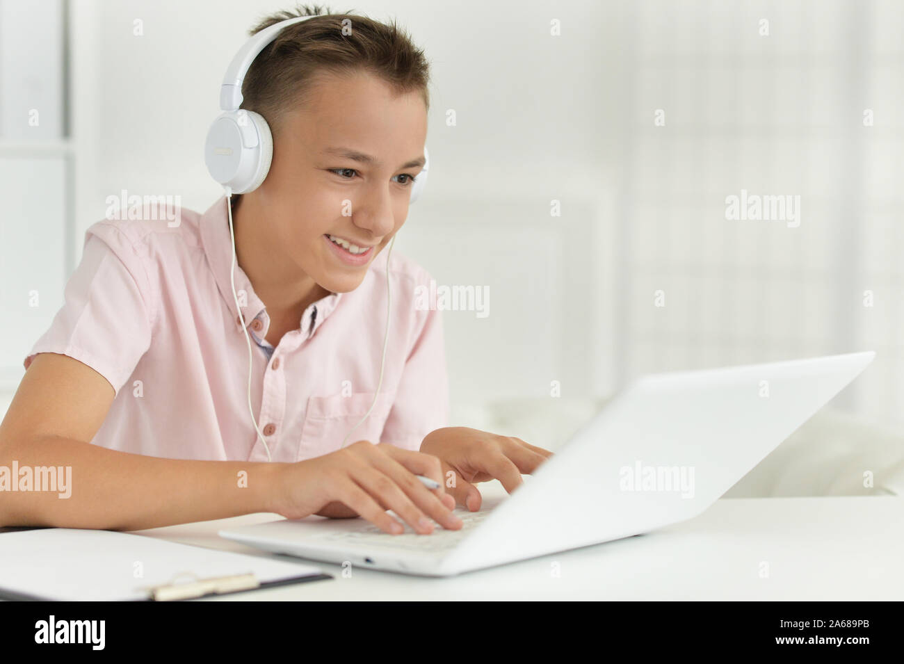 Portrait of cute boy using laptop in room Stock Photo - Alamy