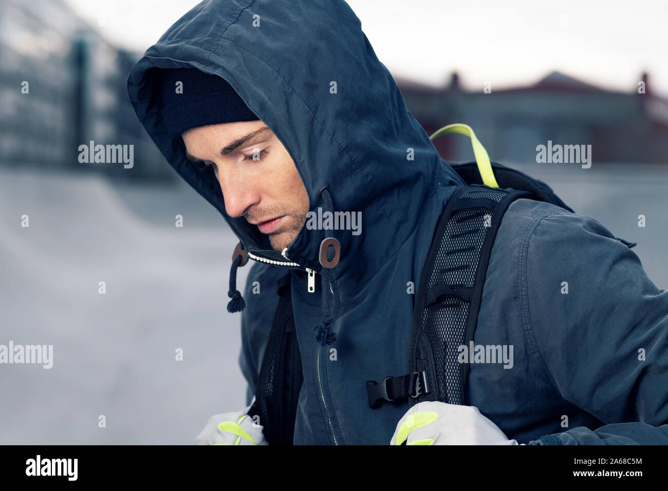 Portrait of a young attractive man wearing a hooded jacket Stock Photo
