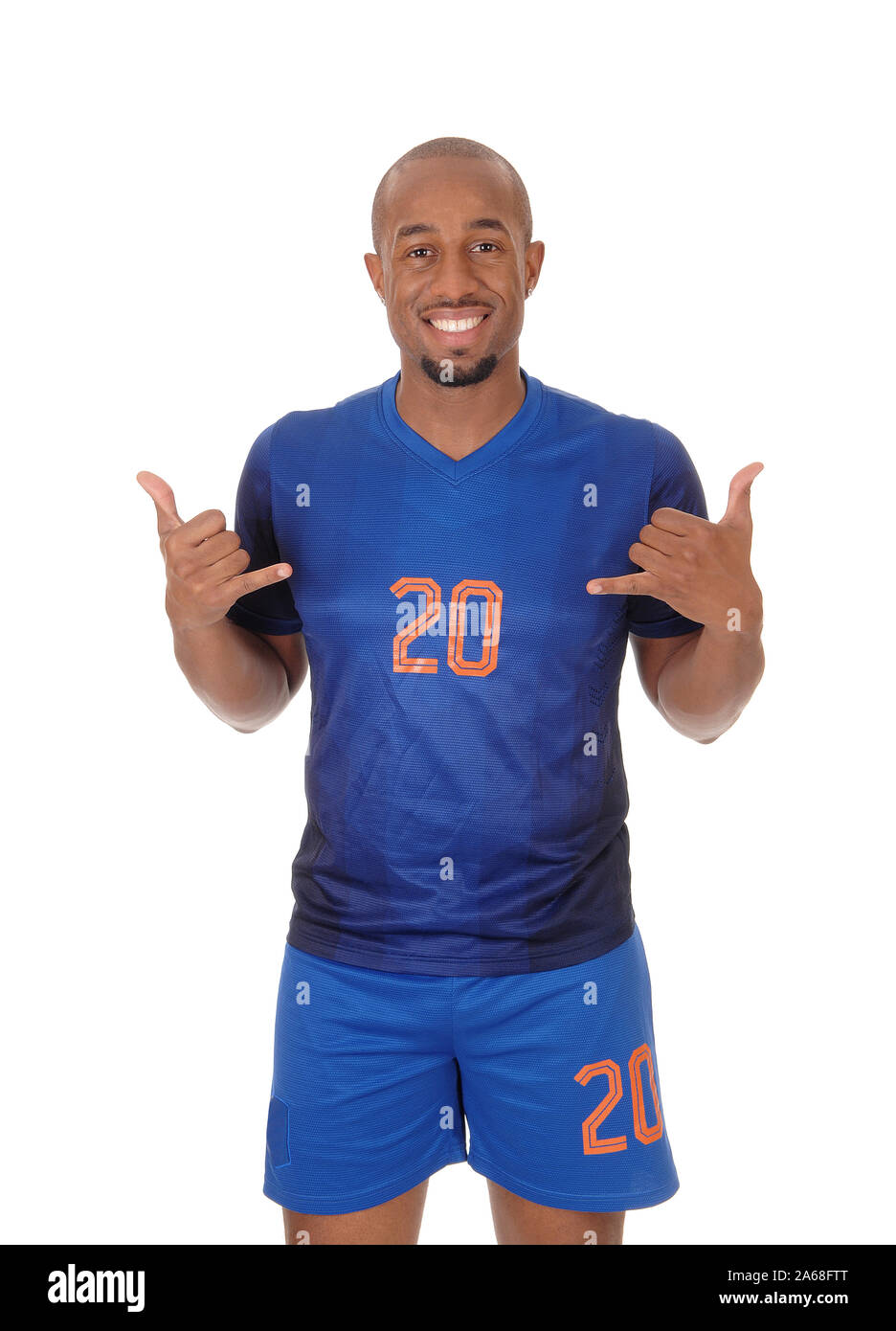 A young African American soccer player standing in the studio in his blue uniform pointing to himself, isolated for white background Stock Photo