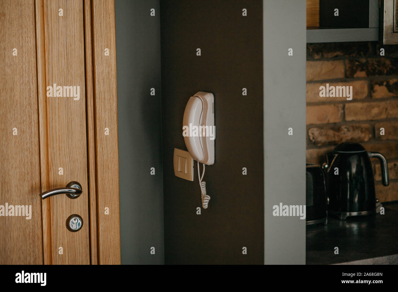 Intercom on the wall in a residential apartment. Stock Photo