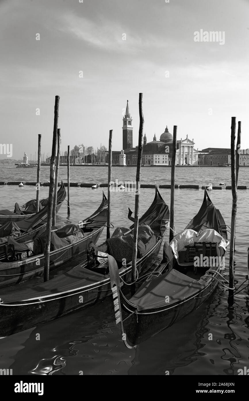 Chiesa di San Giorgio Maggiore, Venice, Italy, across the Basin of St. Mark: a line of moored gondolas in the foreground.  Black and white version Stock Photo