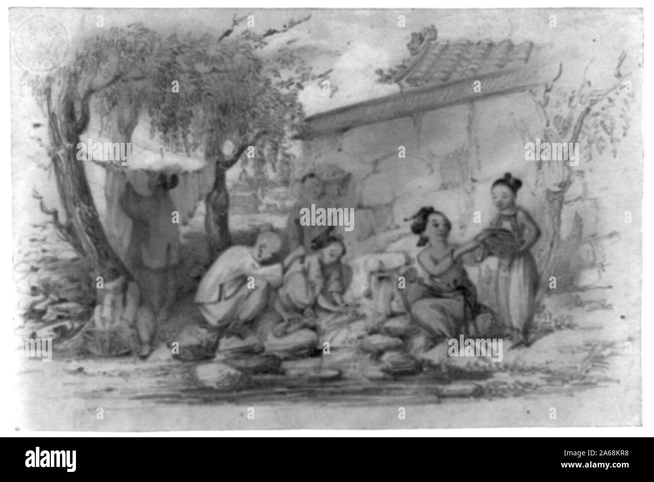 Women and girls, outside a building, washing clothes in a stream by pounding and rinsing, and hanging on a rope strung between two trees Stock Photo