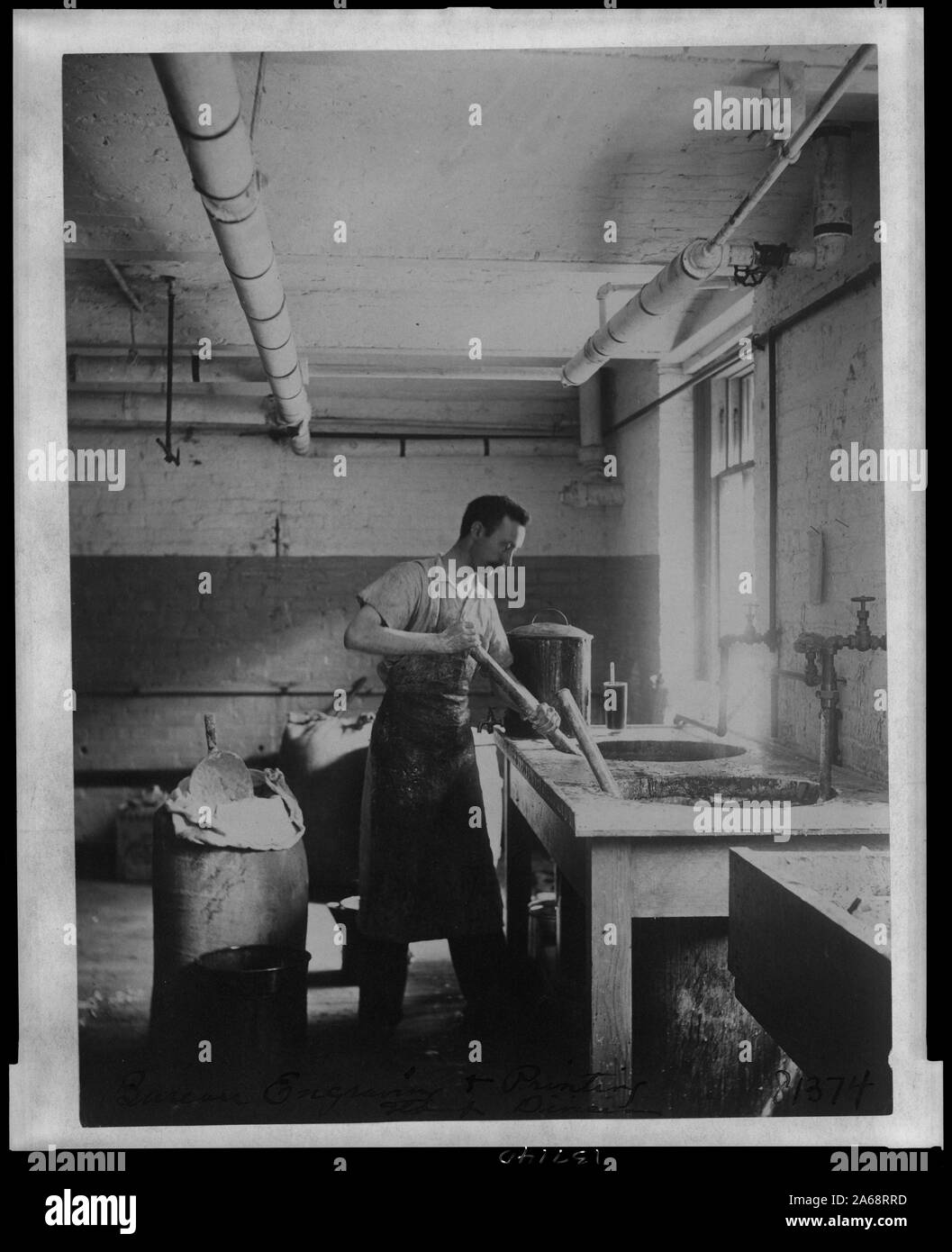 Worker prepares gum for postage stamps in the Stamp Division at the Bureau of Engraving & Printing Stock Photo