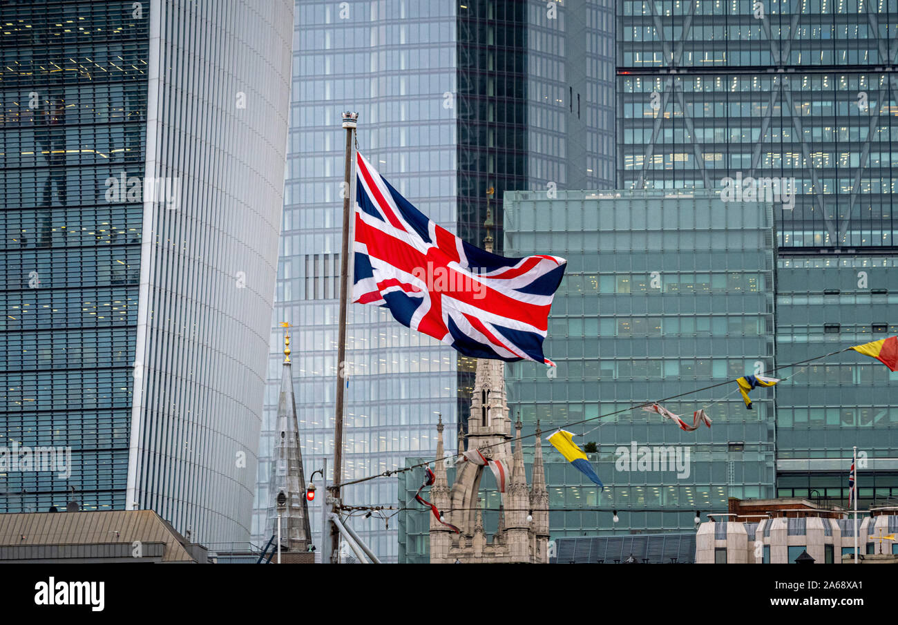 Union Jack Flag on HMS Belfast with London skyscrapers in background. Stock Photo