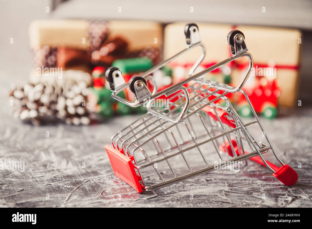 Vintage Christmas background with Christmas Gift on a concrete background. Christmas and New year sale concept. Buy nothing day. Dropped shop cart. Stock Photo