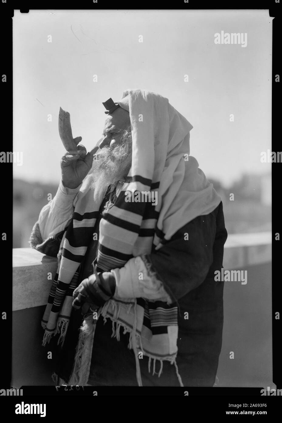 Yemenite Rabbi Avram arrayed for prayer, blowing the shofar Stock Photo