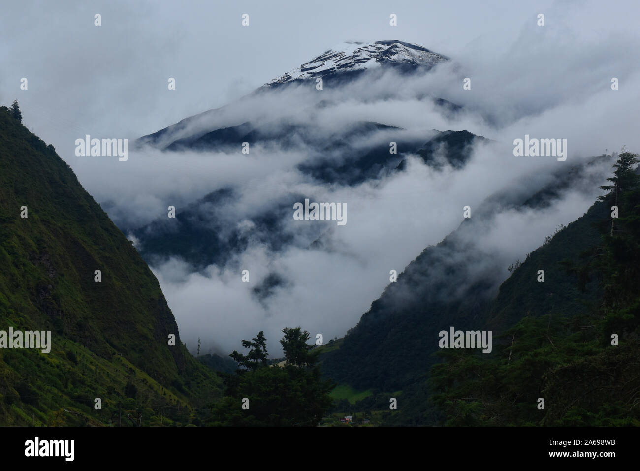 Tungurahua volcano above the clouds, Baños de Agua Santa, Ecuador Stock Photo