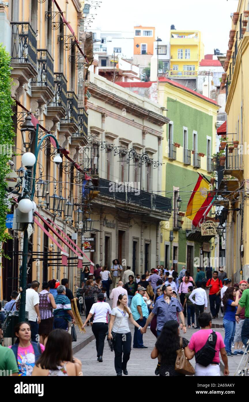 Street scene in Guanajuato, Mexico. Crowd walking the Spanish Colonial streets. Stock Photo
