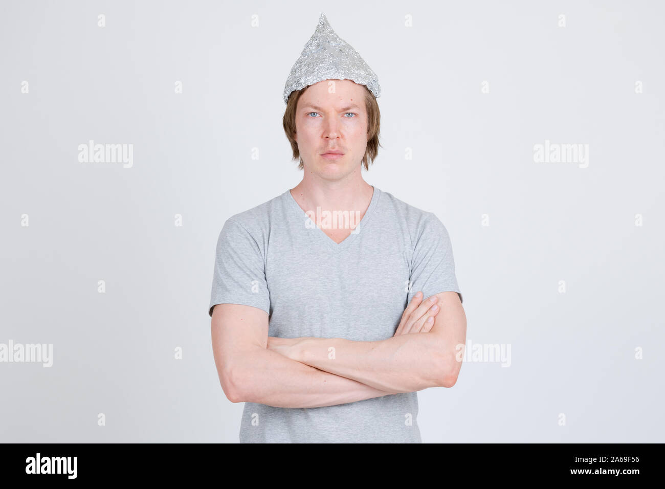 Young man with tinfoil hat as conspiracy theory concept Stock Photo