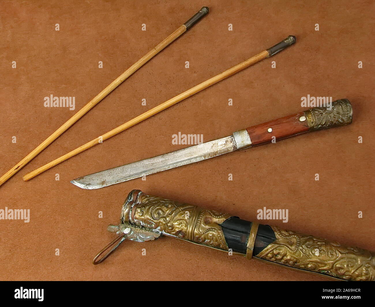 Vintage Asian knife, chop sticks, and ornate hard sheath Stock Photo