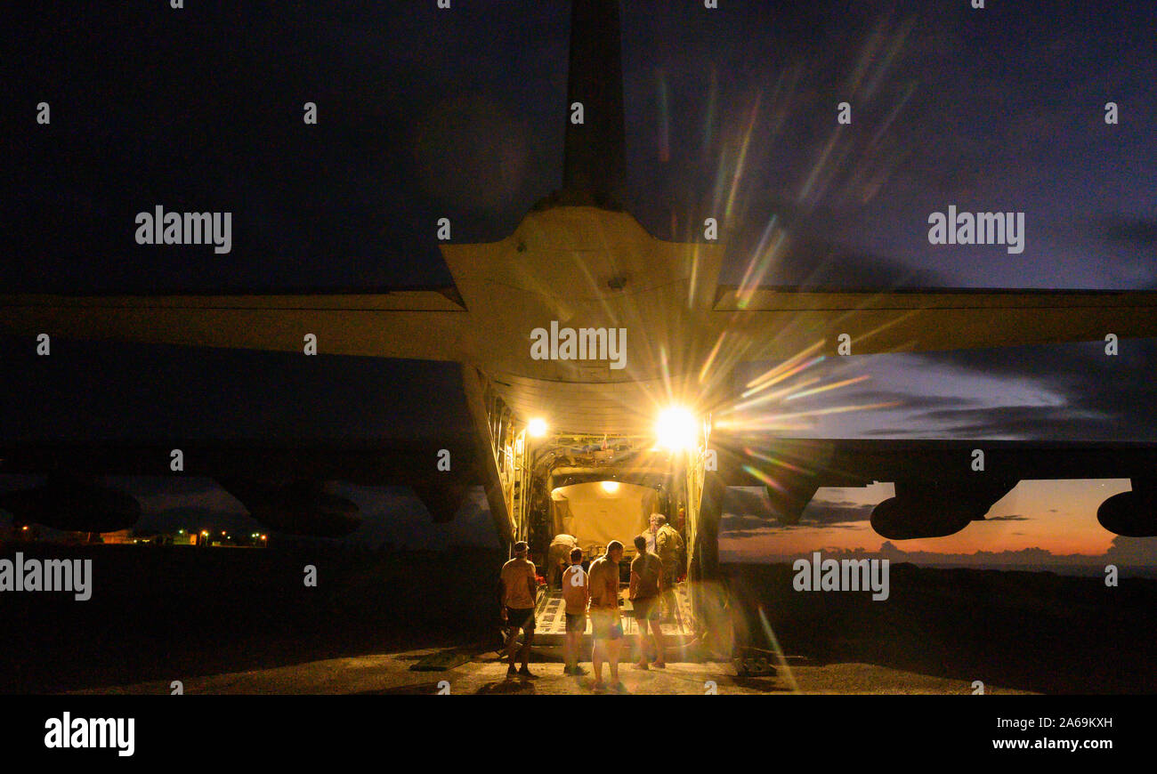 U.S. Airmen with 31st and 33rd Rescue Squadron, off-load equipment from a C-130J Super Hercules during exercise Beverly High 20-1 at Ie Shima airfield, Japan on Oct. 21, 2019. The exercise was an integration of Marines and Airmen designed to rehearse combat employment of rescue forces to an austere location and establish communications in any environment. (U.S. Marine Corps photo by Cpl. Kallahan Morris) Stock Photo