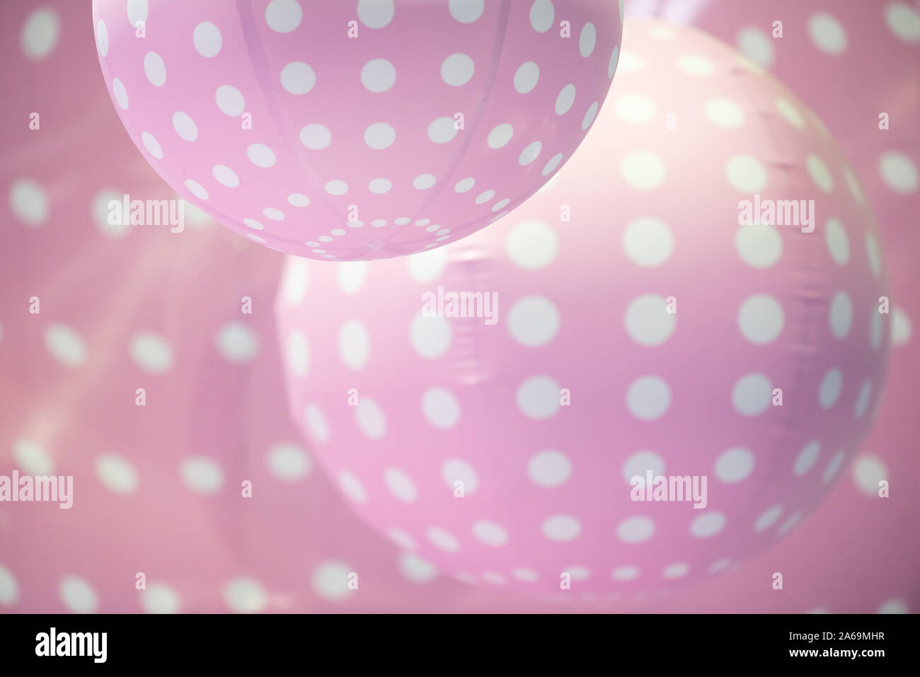 Pink plastic balls with white dots background Stock Photo Alamy