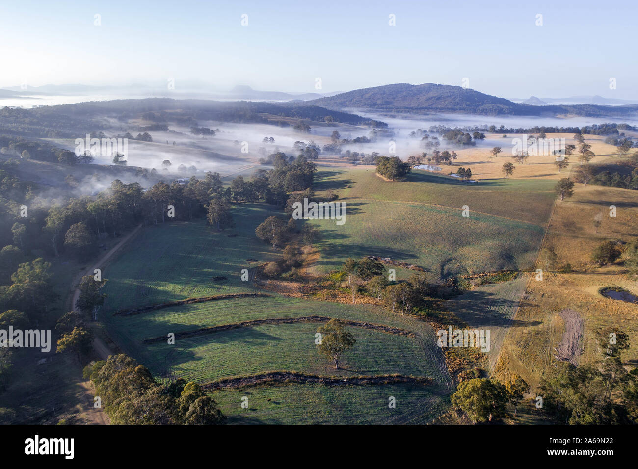 Aerial view over a morning fog and countryside landscape. Beautiful fields at sunrise Stock Photo